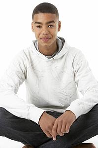 Studio Portrait Of Smiling Teenage Boy