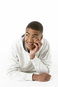 Studio Portrait Of Smiling Teenage Boy