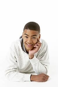 Studio Portrait Of Smiling Teenage Boy