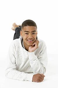 Studio Portrait Of Smiling Teenage Boy