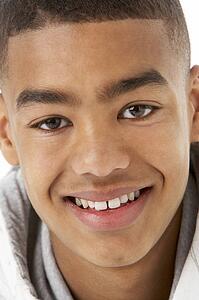 Studio Portrait Of Smiling Teenage Boy