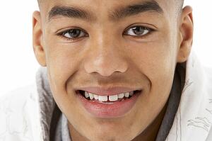 Studio Portrait Of Smiling Teenage Boy