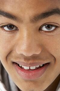 Studio Portrait Of Smiling Teenage Boy