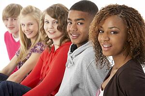 Studio Portrait Of Five Teenage Friends Standing In Line
