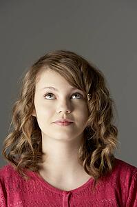 Studio Portrait Of Teenage Girl Looking Up