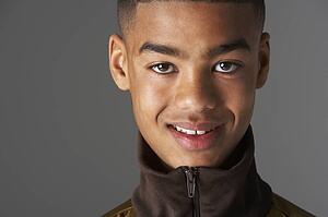Studio Portrait Of Fashionably Dressed Teenage Boy