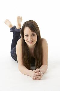 Studio Portrait Of Teenage Girl On White Background