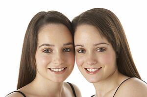 Studio Portrait Of Teenage Twins