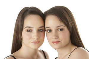 Studio Portrait Of Teenage Twins