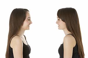 Studio Portrait Of Teenage Twins