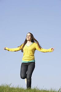 Teenage Girl Running Through Summer Meadow
