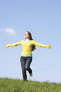 Teenage Girl Running Through Summer Meadow
