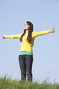 Teenage Girl Standing In Summer Meadow