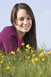 Teenage Girl Laying In Summer Meadow