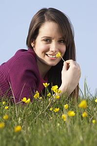 Teenage Girl Laying In Summer Meadow