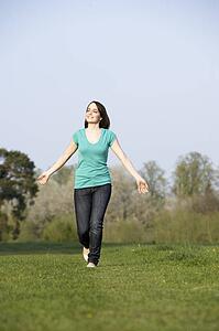 Teenage Girl Running Through Summer Meadow