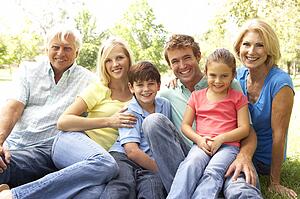 Extended Group Portrait Of Family Enjoying Day In Park
