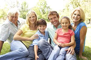 Extended Group Portrait Of Family Enjoying Day In Park