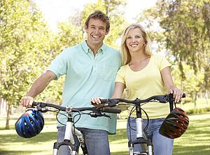 Young Couple On Cycle Ride in Park