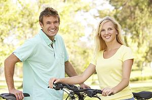 Young Couple On Cycle Ride in Park