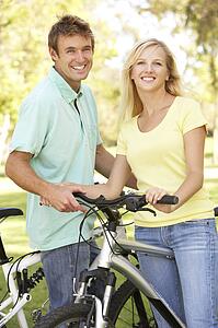 Young Couple On Cycle Ride in Park