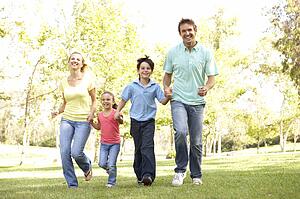 Family Running In Park