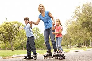 Grandmother And Grandchildren Skating In Park