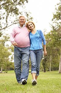 Senior Couple Walking In Park