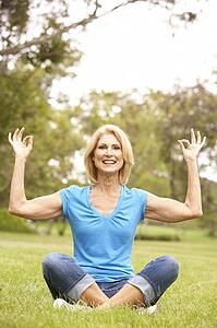 Senior Woman Doing Yoga In Park