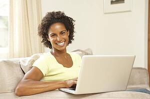 Woman Using Laptop At Home