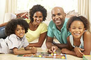 Family Playing Board Game At Home
