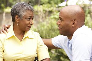 Senior Woman Being Consoled By Adult Son