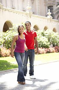 Young Couple Walking Through City Street