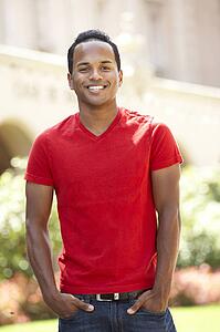 Young Man Walking Through City Street