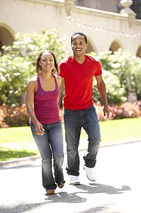 Young Couple Walking Through City Street