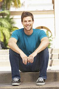 Young Man Sitting On Steps Of Building