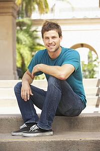 Young Man Sitting On Steps Of Building