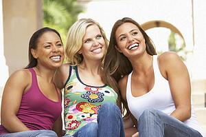 Three Girlfriends Sitting On Steps Of Building