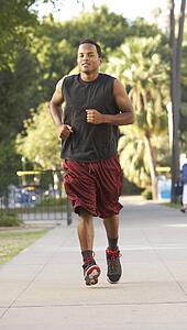 Young Man Jogging On Street