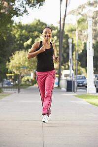 Young Woman Jogging On Street
