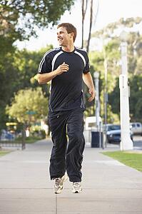 Young Man Jogging On Street