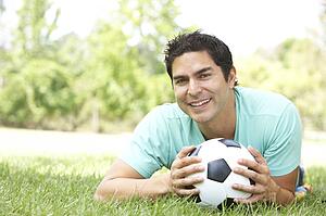 Portrait Of Young Man In Park With Football
