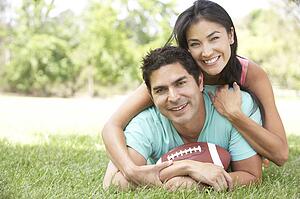 Couple In Park With American Football