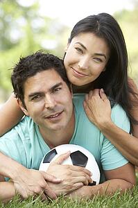 Couple In Park With Football