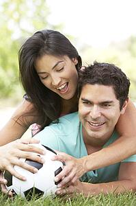 Couple In Park With Football