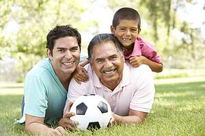 Grandfather With Son And Grandson In Park With Football