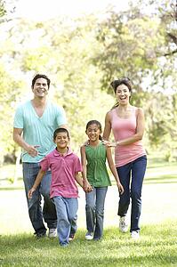 Young Family Having Fun In Park
