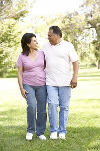 Senior Couple Walking In Park