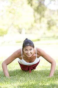 Young Woman Exercising In Park