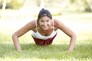 Young Woman Exercising In Park